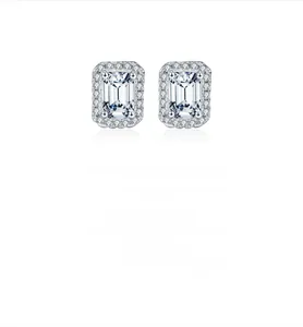 Macro detail of emerald-cut moissanite silver earrings with halo diamonds and reflections