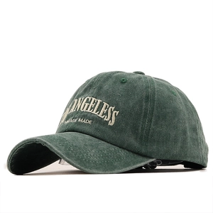 Distressed dark green baseball cap with cream vintage embroidery on front view