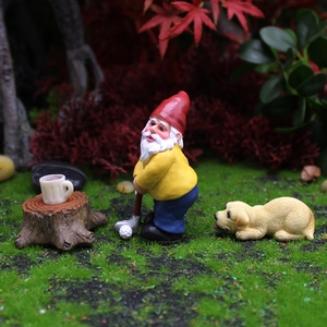 Garden gnome playing golf with a puppy and stump accessories on green grass