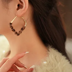 Golden diamond-shaped leopard print plush earrings with minimalist vintage geometric style