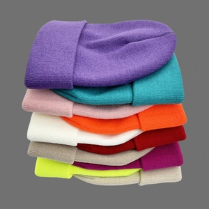 Stack of multi-colored double-layer knit beanies for autumn and winter outdoor warmth