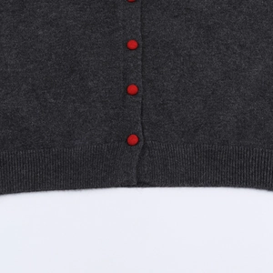 Dark grey knitted cardigan for women featuring contrast red buttons and ribbed hem detail