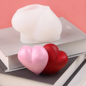 Detail of 3D heart silicone mold for DIY candles with pink and red wax heart finished samples