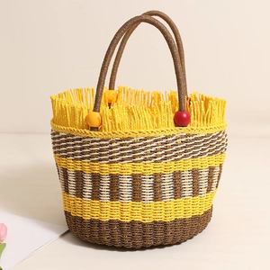 Handmade woven straw bucket bag with colorful wood beads and a round handle for beach vacations