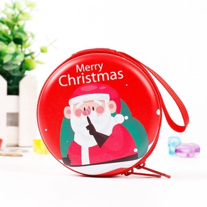 Close-up of red tinplate Christmas coin purse with Santa Claus print and zipper