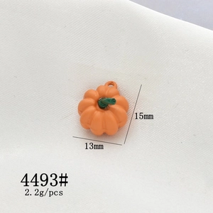 Detail view of 15mm orange pumpkin charm with green stem for DIY jewelry making