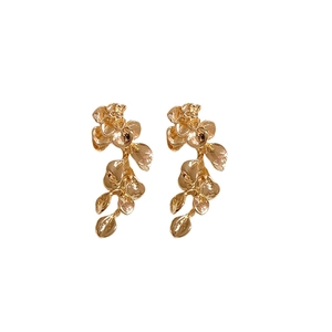 Elegant gold metal flower tassel earrings with textured leaf petals on a white background