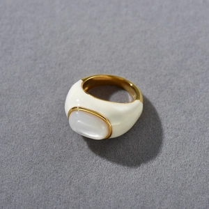 Detail of 18k gold plated ring with oval white shell inlay and minimalist metal frame
