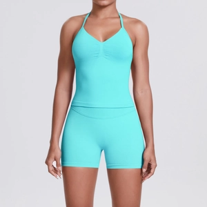 Detail view of cyan halter neck sports bra and high-waist shorts with knitted texture