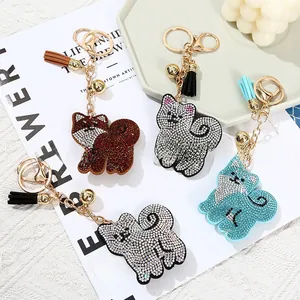 Macro shot of cute cartoon cat keychains with rhinestones, tassels and golden bells