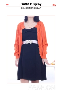 Detail of white thin waist belt with silver double flower buckle on black dress
