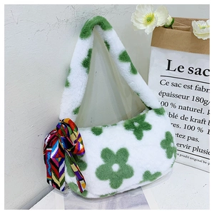 Detail of white plush shoulder bag featuring green floral patterns and colorful silk scarf
