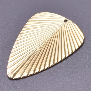 Macro view of a 18k gold plated stainless steel leaf pendant showing vein texture details