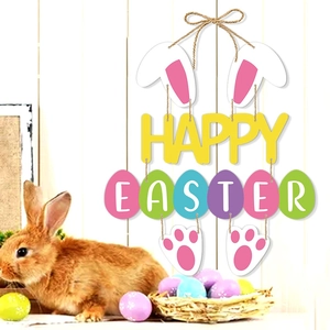 Happy Easter hanging sign with rabbit ears and colorful egg plates on white wood wall