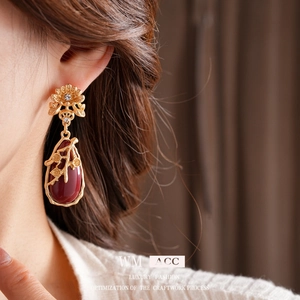 Vintage gold-tone drop earrings with deep red gemstone and intricate floral crystal design