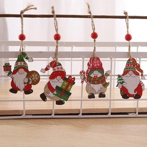 Set of four wooden Christmas gnome ornaments hanging on a white basket for display