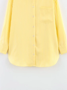 Detail of yellow and white striped shirt showing front buttons and chest pocket