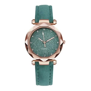 Detail of rose gold quartz watch featuring a green glitter dial and leather strap