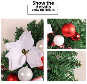 Detail of Christmas garland featuring artificial pine needles and white glitter poinsettia flower