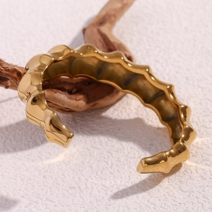 Macro shot of 18K gold plated stainless steel spiral bamboo open bangle design