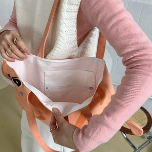 Detail view of pink canvas tote bag featuring inner zipper pocket and cute cat print