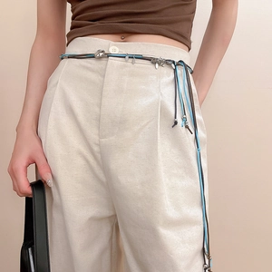 Detail of multi-strand sky blue and dark brown waist chain with floral metal charms