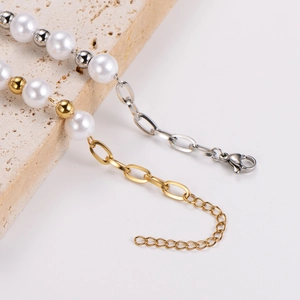 Minimalist stainless steel pearl bracelet with gold and silver lobster clasp extensions