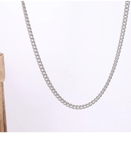 Close-up of a minimalist silver stainless steel O-chain necklace on a white background