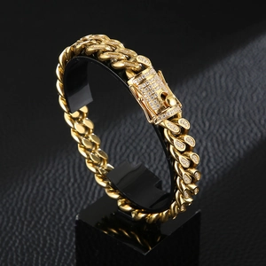 Luxury gold plated Cuban link bracelet with CNC diamond inlay on a black display