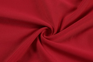 Detailed macro view of deep red ribbed knit fabric with fine horizontal texture