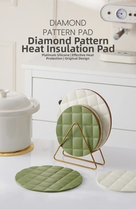 Close-up of diamond pattern silicone heat resistant mats in green and cream colors