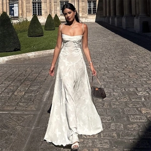 Elegant white maxi dress with delicate 3D butterfly embroidery in a street style shot