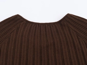 Detail shot of dark brown knit top featuring ribbed texture and neckline finish