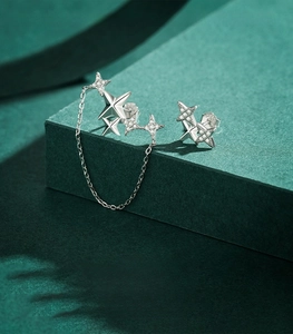 Macro view of 925 sterling silver star stud earrings with zirconia and chain detail