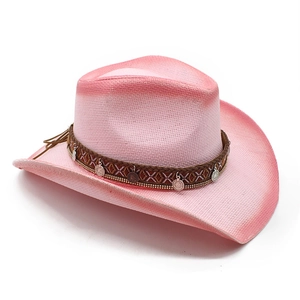 Detail of pink straw cowboy hat with ethnic braided band and metal coin charms