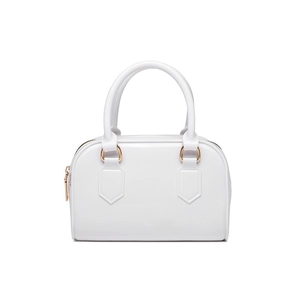 Detail of white jelly boston bag featuring glossy finish and elegant metal handles