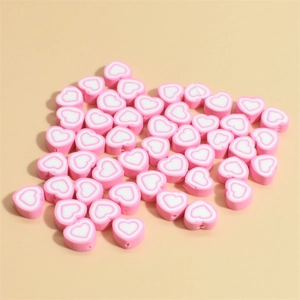 Scattered 10mm pink heart polymer clay beads with white outline for DIY jewelry making