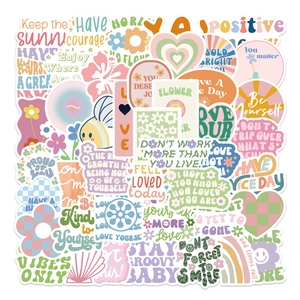 Close-up of Danish pink stickers with motivational quotes for luggage and laptops