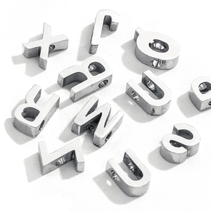 Macro detail of various 3D stainless steel alphabet pendants for DIY jewelry making