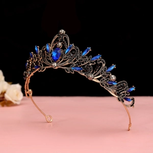 Detailed close-up of a baroque bronze tiara with dark blue waterdrop crystals and black gems