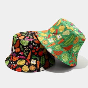 Reversible bucket hats with vibrant vegetable prints in black and green cotton fabric