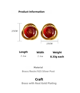 Detailed specs of vintage gold spiral earrings with red resin and gold foil leaf