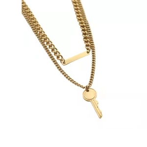 Double-layered gold key necklace with rectangle pendant on white background