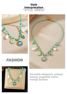 Detail of bohemian braided necklace featuring evil eye, moon, and shell pendants