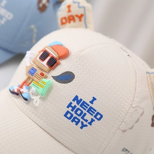 Detail of baby baseball cap with 3D silicone cartoon robot and pixel font letters