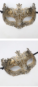Detail of vintage gold masquerade mask with ornate filigree and crown-style top