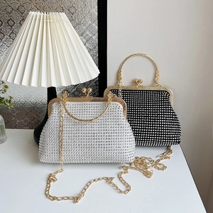 Elegant rhinestone evening bag in black and silver with gold metal handle and chain strap
