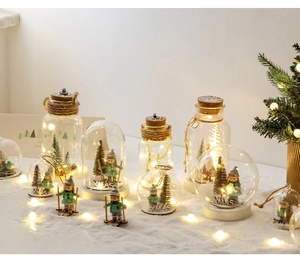 Detail of a Christmas glass snow globe with LED lights, resin reindeer, and wooden base