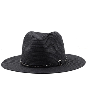 Close-up of black straw fedora hat featuring a stylish studded band and metal ring detail