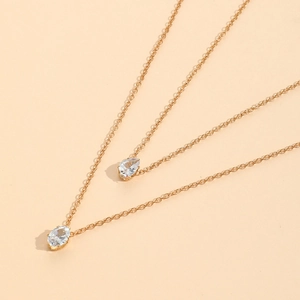 Double-layered gold necklace featuring two elegant pear-shaped zircon stone pendants